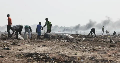 Extreme poverty men digging toxic garbage Accra Ghana 4K Stock Footage 157536906