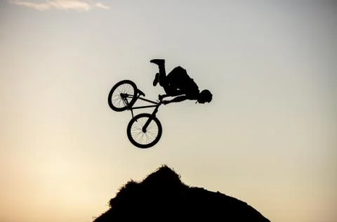 Extreme rider falling while making a bike jump Stock Photos