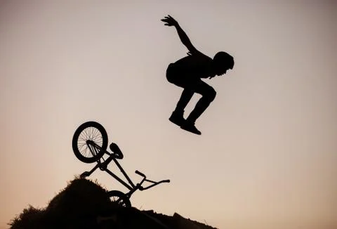 Extreme rider falling while making a bike jump Stock Photos