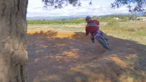 Extreme rider performs drifting on enduro motocross motorcycle on gravel track Stock Footage 124231903