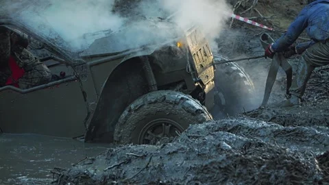 Extreme off-road vehicle stuck deep in a mud bog during a competition Stock Footage 344876720