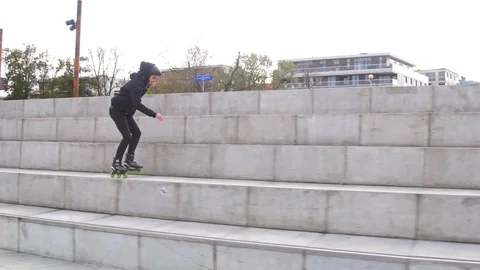 Extreme skating in city on inline skates with jumps in slow motion Stockbeeldmateriaal 120445512