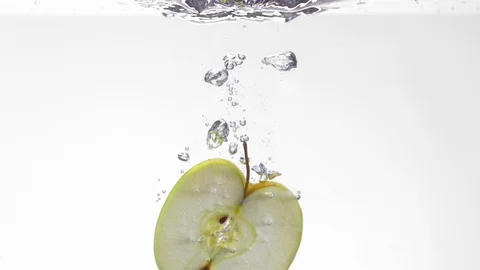 Extreme Slow Mo Of Apple Slice Falling Into Water Stock Footage 125990251