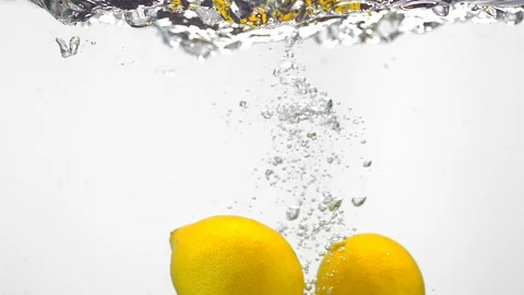 Extreme Slow Mo Of Fresh Lemons Being Dropped Into Water Stock Footage 125990245