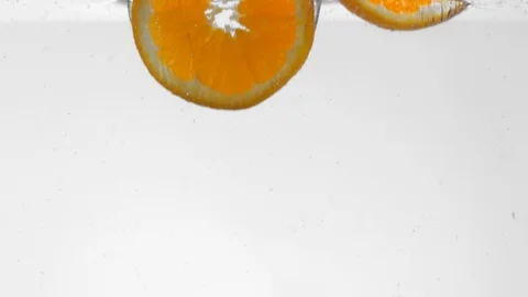 Extreme Slow Mo Of Fresh Orange Slices Falling Into Water Stock Footage 125990624