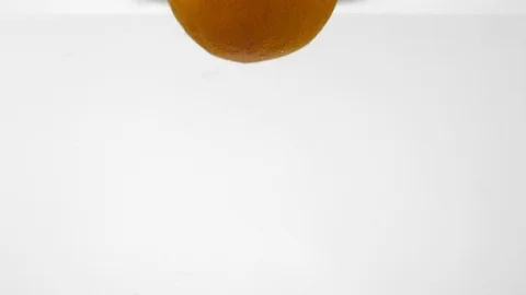 Extreme Slow Mo Of Whole Orange Falling Into Water Stock Footage 125991678