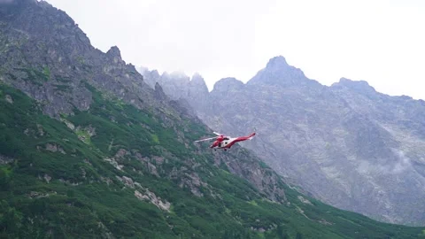 Extreme slow motion flying rescue helicopter near mountains with fog. Poland Stock Footage 212950596
