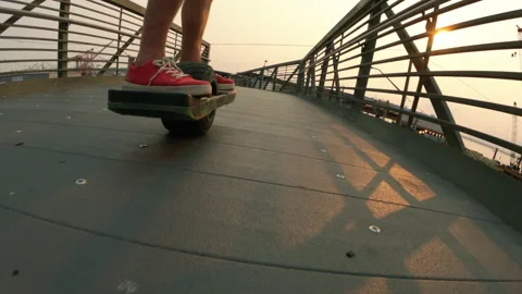 Extreme Sports POV Following Electric Board with One Wheel Over City Bridge Stock Footage