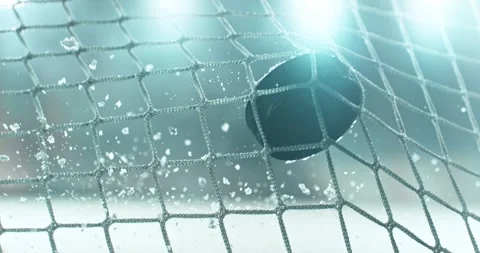 Extreme super slow motion close-up of an ice hockey puck striking the goal net Stock Footage 329682870