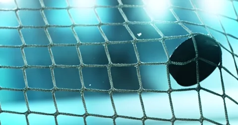 Extreme super slow motion close-up of an ice hockey puck striking the goal net Stock Footage 329682873