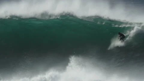Extreme Surfer riding a big wave. Big Tube Barrel Wave. Nazaré 2023 Stock Footage 232928705