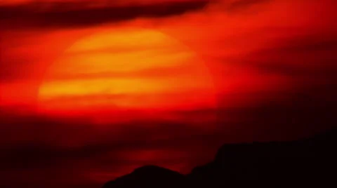 Extreme tele sunset,big sun setting behind mountain,hazy atmosphere Stock Footage 49856949