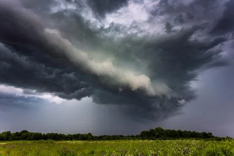 Extreme thunderstorm shelf cloud moving over fields, climate change concept Stock Photos