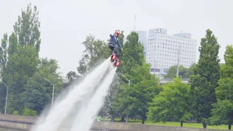 Extreme water sport. Fly Board on city river in park. Slow motion. Flyboard. Stock Footage