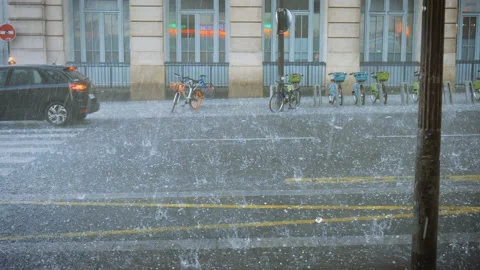 Extreme weather hail rain storm on the streets of Paris hail beats bicycles Stock Footage