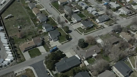 Extreme wide aerial pull back as Garbage Truck drives down Neighborhood Video stock 116257497