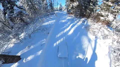 Extreme wide angle looking behind a snowmobile that is towing a trail groomer Stock Footage 233224907