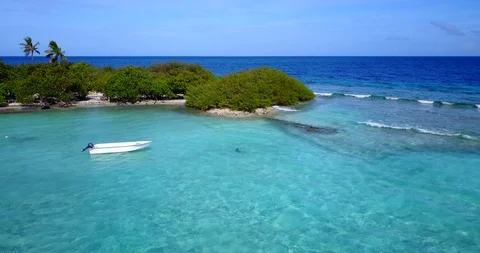 Extreme wide shot of a lovely tiny island in the  Caribbean, a single man Stock Footage 117906745