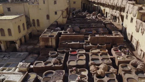Extreme wide top down shot of tannery leather workers dyeing leather in Fes Stock Footage 265495218