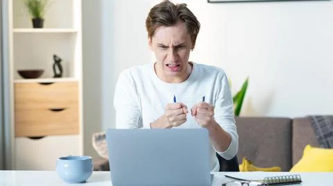 Extremely Angry Young Man Breaking a Pencil out of Rage Stock Photos