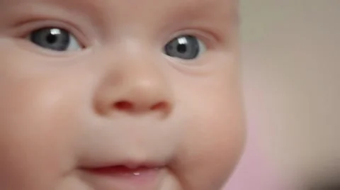 Extremely close up of baby's face as it looks around. Notice the reflections in Stock Footage 61676557