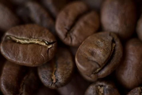 Extremely close-up background roasted coffee beans with gold streaks, good mo Stock Photos