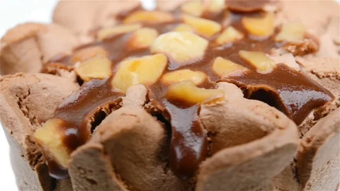 Extremely close up of chocolate flavor ice cream cone rotating on white Stock Footage 83449846