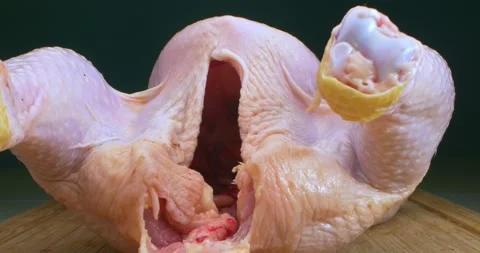 Extremely close-up, detailed. inside and outside view of raw chicken carcass Video stock 148762022