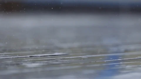 Extremely close up of raindrops falling on wooden deck Slow motion Macro Stock Footage 96117672