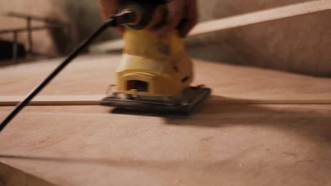 Extremely close shooting of manual grinding process in carpenter's hand. Stockbeeldmateriaal 110352282