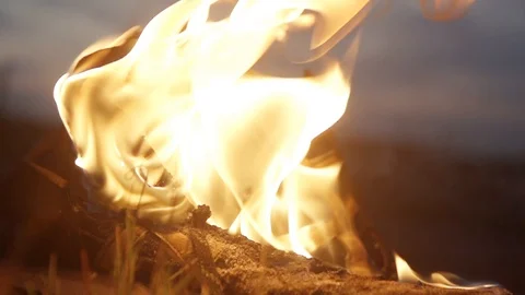 Extremely close-up shot of shoes on fire strong bright flame summer dark night Stock Footage 95910372
