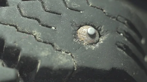 Extremely close-up of a steel spike on an old tyre Video stock 97986264