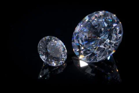 Extremely close-up of two beautiful chic crystals on a deep black mirror Stock Photos