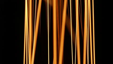 Extremely close view. Macro. Tungsten filaments glow with a warm orange light Stock Footage 158328314