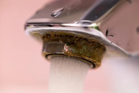 Extremely close up water run and flow from steel faucet. Macro flowing tap water Stock Photos