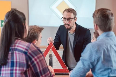 Extremely competent driving instructor in class with his students Stock Photos