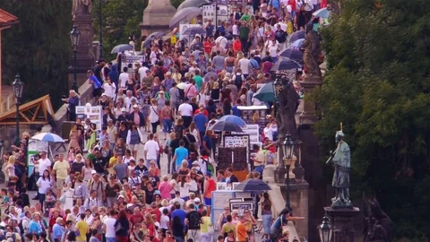 Extremely crowded entry to Charles Bridge in Prague Stock Footage 82758008