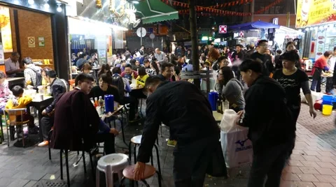 Extremely crowded street eatery area, road restaurants in night time Stock Footage 50016847