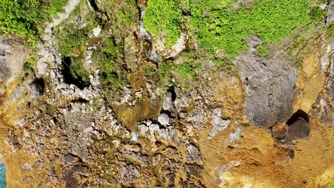 Extremely dangerous footpath on a cliff wall to Seganing Waterfall. Rocky cliff Stock Footage 162544007