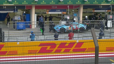 Extremely fast Car Race Pit Stop and Tire Changing during a Race in Bahrain Stock Footage 172268478
