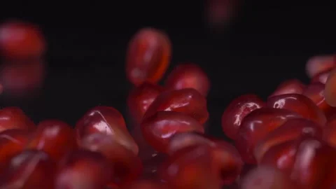 Extremely healthy. Super slow motion shot of pomegranate seeds falling and Video stock 147412186