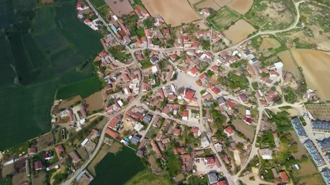 Extremely high-altitude top-down aerial drone footage of a rural village Stock Footage 323324491
