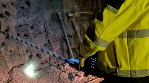 Extremely long drill for drilling TNT holes in walls at underground coal Stock Footage 255180665