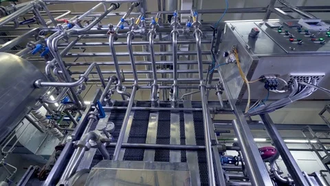 An extremely low view on a dairy factory control box connected to pipes. 4K. Stock Footage 80597001