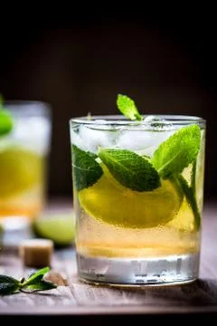 Extremely nice composition of Mojito half glass with mint and lime on the wooden Stock Photos