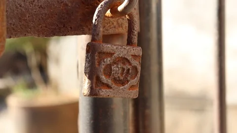 Extremely Old Rusted Chain Lock hanging on old door, 1080p 25fps Stock Footage 108142513