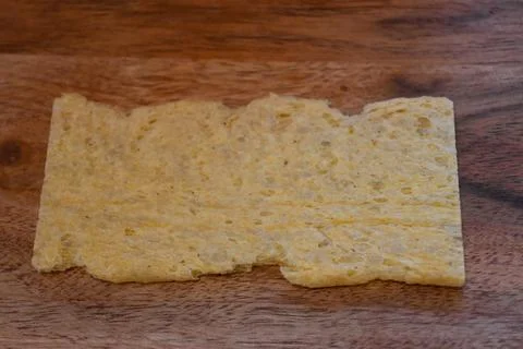 Extruded bread on a wooden surface 스톡 사진