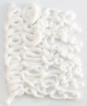 Extruded white moisturizing face or body cream on white background Stock Photos