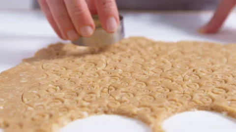 Extruding on the dough with a cookie baking dish. Close-up. 4K. Stock Footage 155015220