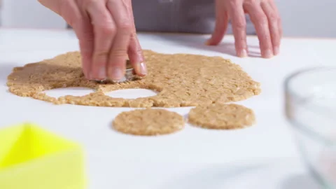 Extruding on the dough with a cookie baking dish. Close-up. 4K. Stock Footage 155015747